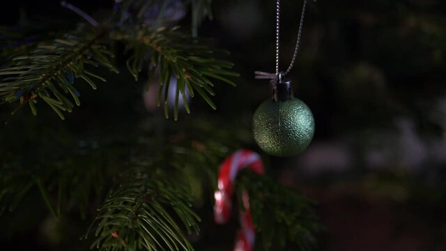 Christmas bauble hanging on a decorated tree close up