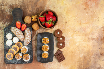 top view different sweets with cookies and fruits on light desk fruit sugar pie cake