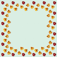 Modern floral frame with yellow and red pansy flowers, small summer flat lay flowery seasonal styling