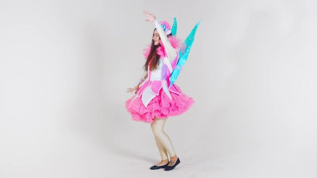 Portrait of a young cute girl in a beautiful costume of a magic fairy isolated on a white background. Animators in costumes. Entertainment for children