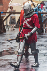 medieval warrior in armor with an ax at the festival of historical reconstruction