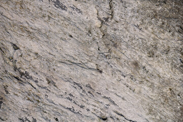 Close-up of textured rock, with small cracks, as a nature background
