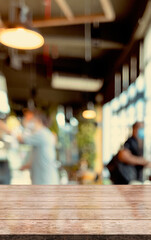 Empty wooden table top with lights bokeh on blur restaurant background.