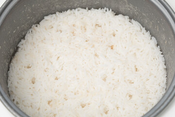 Stream rice in electric rice cooker, close up.