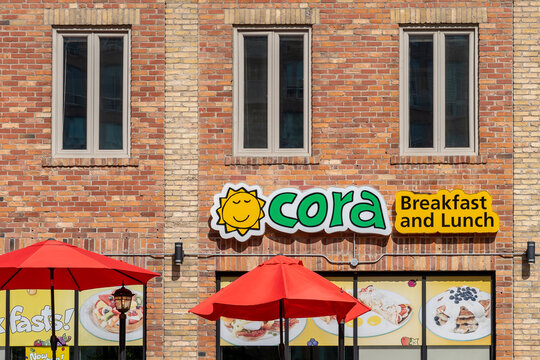 Toronto, Canada - October 12, 2020: Cora restaurant sign on the wall in Toronto. 
Coramark Inc. is a Canadian chain of casual restaurants serving breakfast and lunch. 
