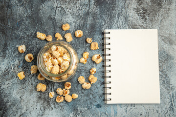 top view sweet popcorn with notepad on light background snack movie cinema