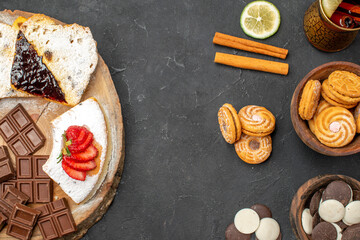 top view cake slices with cookies and chocolate on a dark background biscuit fruit sweet