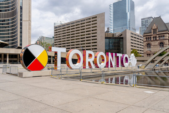 Toronto, Canada - September 29, 2020: Toronto sign on Nathan Phillips Square is seen with Toronto City Hall in background on September 29, 2020.
