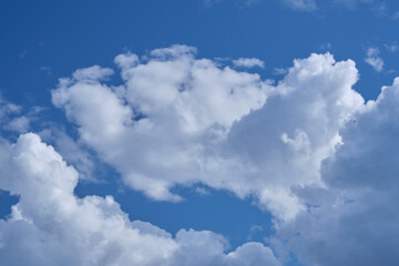 Naklejka na ściany i meble Cumulus clouds against the blue sky, nice background.