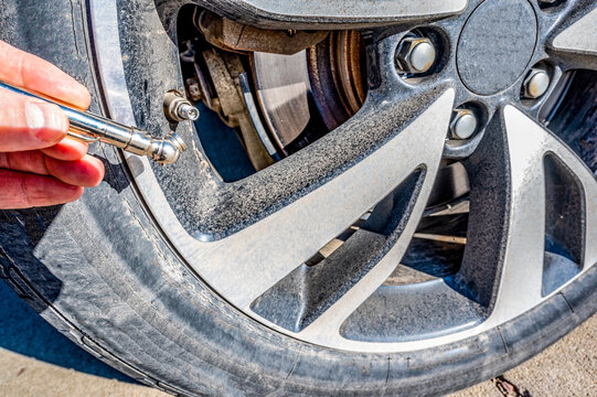 Using A Hand Guage To Check Tire Pressure