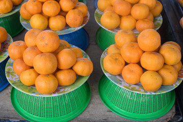 Basket of ripe citrus fruits displayed in a market ready to be bought and enjoyed