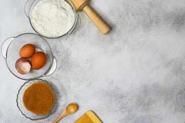 Obraz na płótnie Canvas baking ingredients, eggs, flour and brown cane sugar, quarantine home baking concept, food background