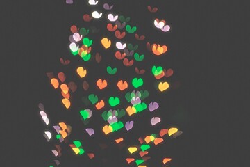 bokeh of light in the form of bright colored hearts