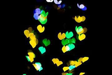 bokeh of light in the form of bright colored hearts