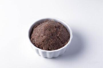 Shrimp paste in white ceramic cup on white background