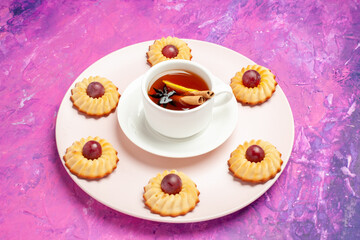 front view yummy grape cookies with cup of tea on pink background biscuit sweet dessert pie