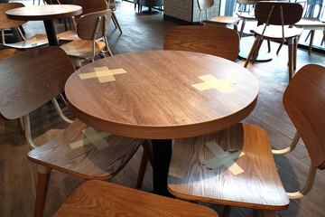 Alternate seating sign in a cafe, keep spaced between each chair make separate for social distancing to avoid spreading of Covid-19.