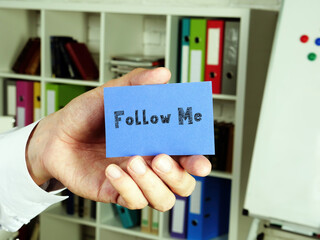 Business concept about Follow Me  with inscription on the sheet.