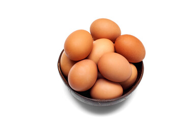 Brown raw chicken eggs in a cup on a white background. Food background.