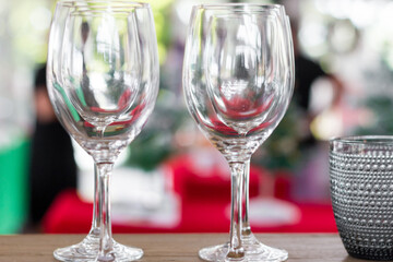 Wine glasses set on a dining table for Christmas