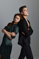 portrait of a man and a woman who leaned their backs on each other front view