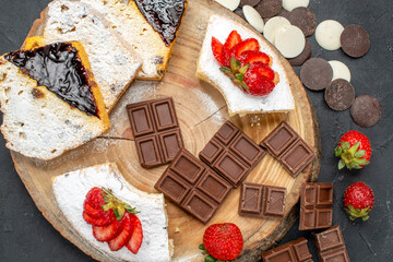 top view cake slices with cookies and chocolate bars on dark background pie sweet fruit