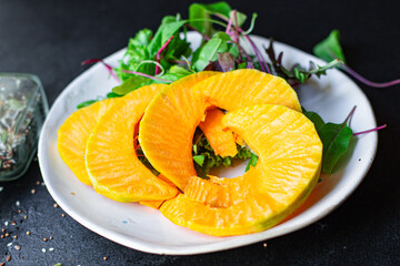 pumpkin salad snack green leaves lettuce, vegetable on the table healthy meal  top view copy space for text food background rustic 