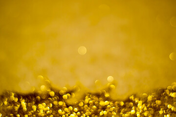 Beautiful blurred glitter background golden color for Christmas decoration.