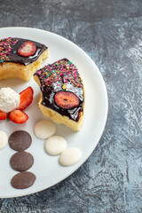 front view delicious cake slices with cookies on dark background dessert biscuit sweet