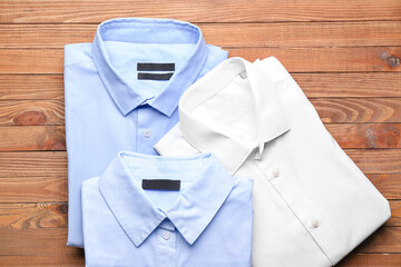 New man shirts on wooden background