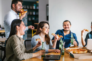 hispanic people coworkers eating pizza and drinking beer in office at Mexico city Happy Hour