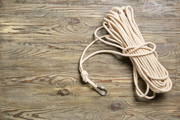 Rope with lobster clasp on wooden background