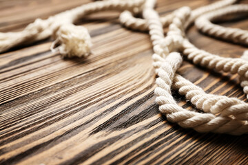 Long rope on wooden background