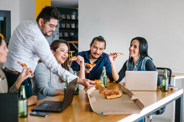 Mexican people coworkers eating pizza and drinking beer in office at Mexico city Happy Hour