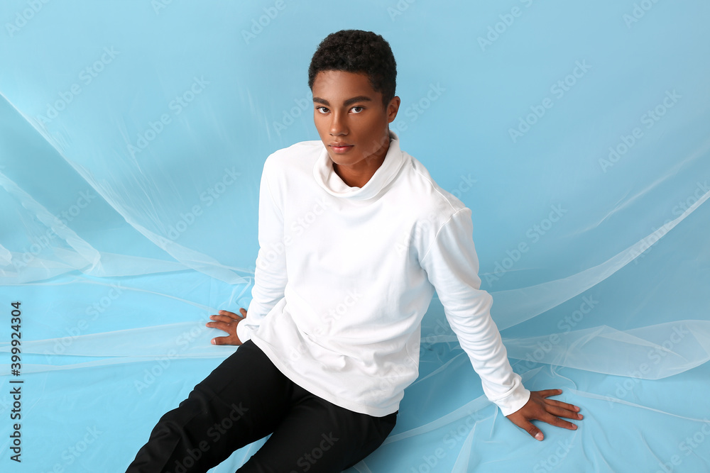 Poster Stylish young African-American man on color background