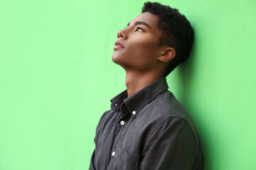 Fototapeta premium Stylish young African-American man on color background