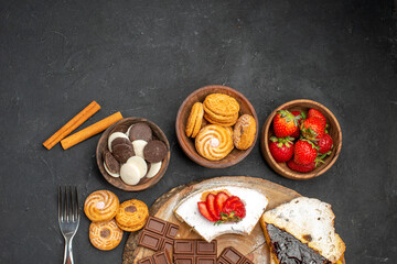 top view cake slices with cookies and chocolate on dark background biscuit fruits sweet