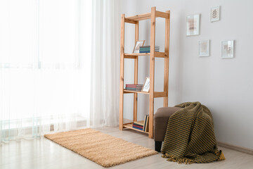 Interior of modern room with shelf unit and ottoman chair
