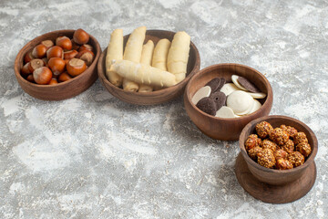 front view sweet bagels with cookies and nuts on white background sweet cake biscuits