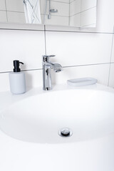 White Stone basin and steel mixer in bathroom
