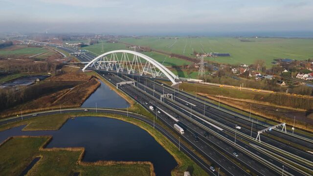 Zandhazenbrug arch bridge over the A1 highway in Muiderberg, The Netherlands Aerial hyperlapse timelapse flying along the motorway
