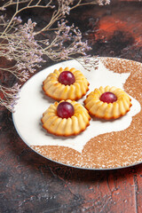 front view yummy little cookies inside plate on dark background cake sweet biscuits