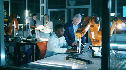 Team of engineers are holding a research over a robotic device - Powered by Adobe