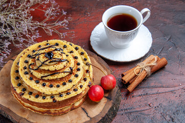 front view delicious sweet pancakes with cup of tea on dark background dessert milk cake