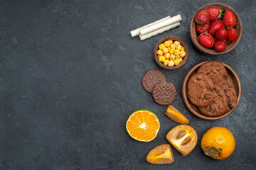 top view fresh red strawberries with sweet biscuits on dark background fresh sugar cookie