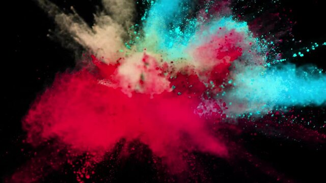 Explosion of red blue yellow powder isolated on black background