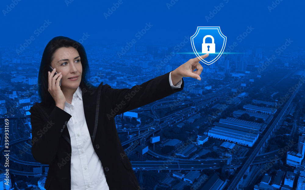 Wall mural caucasian businesswoman talking on her cell phone and pointing finger to padlock with shield flat ic