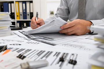 business concept - businessman working with reports in office, table and workspace close view, analyzing financial data, writes and counts