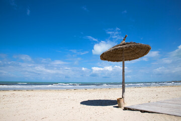beach with umbrella and chairs