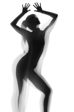 Silhouette of beautiful sexy woman behind curtain on white background